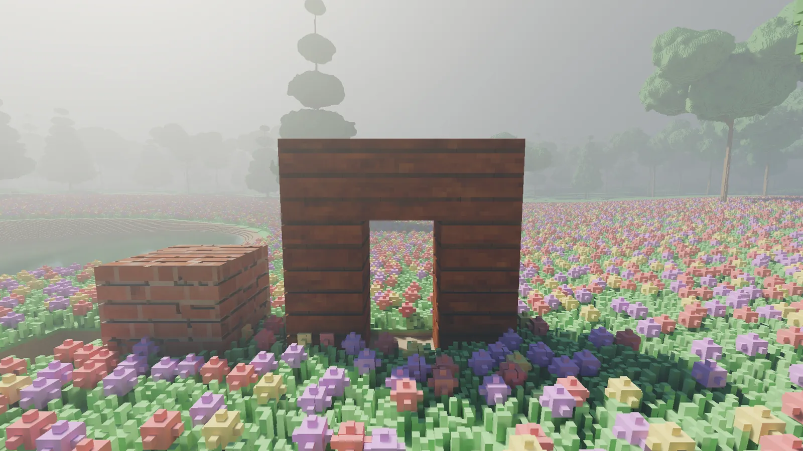 A brick block and a plank wall standing in the meadow, with a doorway carved through the plank wall showing the meadow behind it.