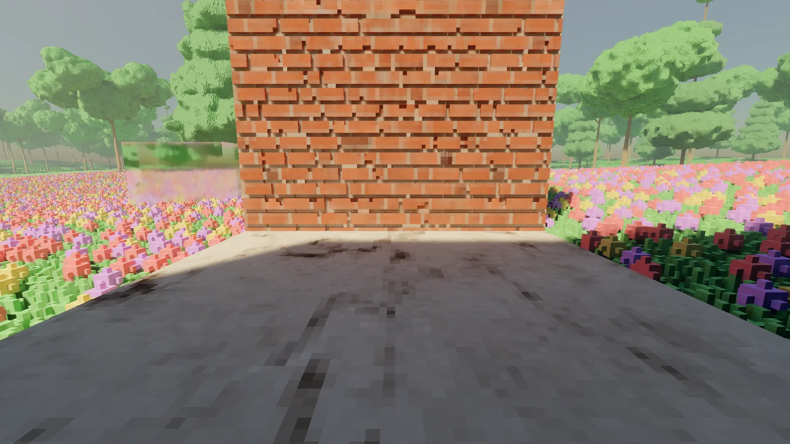 A matte marble floor in shade in front of a brick wall.