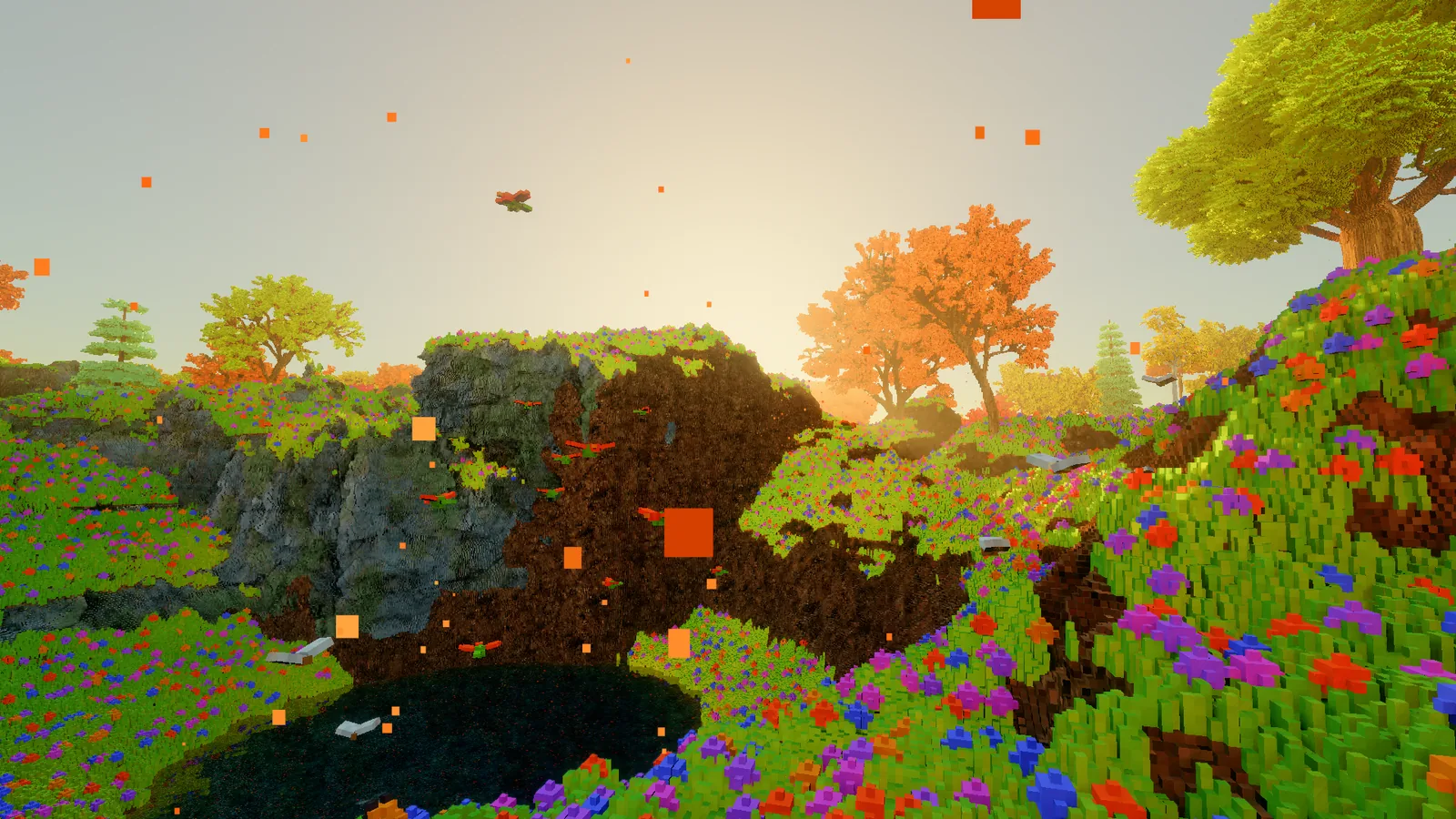 A low sun over a meadow and a rocky outcrop, with orange leaves falling through the air in the foreground.