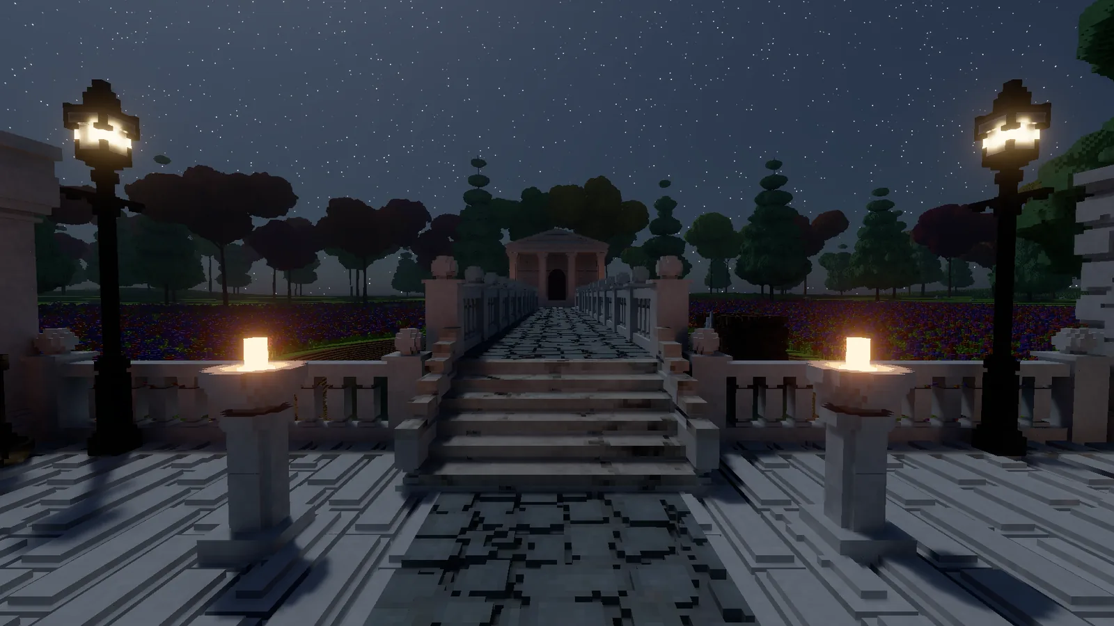 The stairs up to the bridge at night, lit by two fire bowls and two street lamps, with the temple faint in the distance under a starry sky.