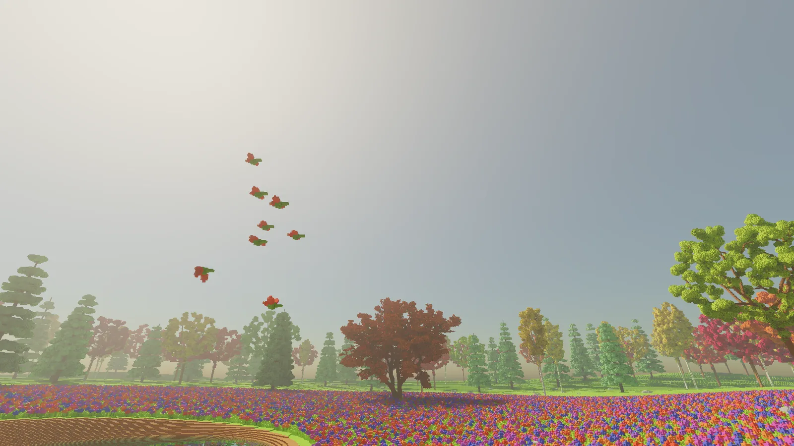 A loose flock of small red-winged birds flying high over the glade, with a red tree and the treeline below.