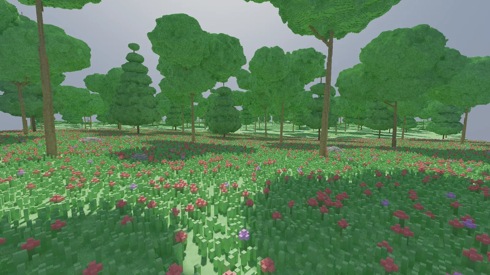 An early version of the voxel glade seen from inside the forest: broadleaf and conifer trees over a meadow of grass and small flowers.